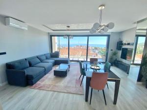 a living room with a blue couch and a table at Villa Tri Brata in Podstrana