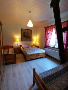 A bed or beds in a room at Mazurski Pejzaż - dom z widokiem i ogrodem