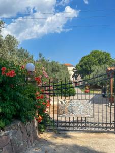 a wrought iron gate with flowers and a fence at Molyvos Stars Apartments in Mithymna