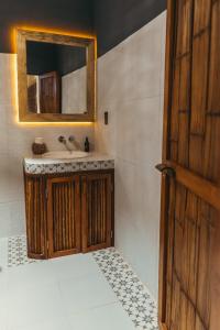 a bathroom with a sink and a mirror at Hotel Sur Bacalar in Bacalar