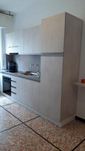 a kitchen with white cabinets and a sink at A casa di Anna in Finale Ligure +26 photos