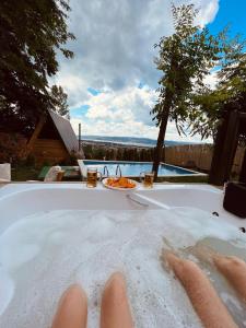 a persons feet in a bath tub with a plate of food at Sapanca Mea Vita in Sapanca