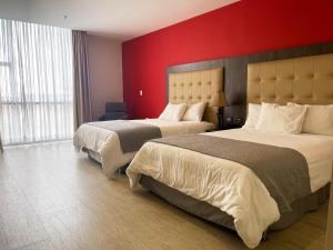 Hotel HR AMADA Cúcuta客房内的一张或多张床位