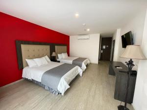 Hotel HR AMADA Cúcuta客房内的一张或多张床位