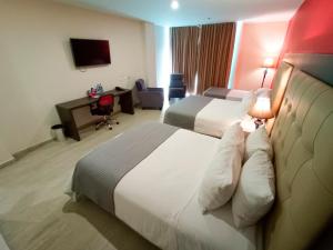 Hotel HR AMADA Cúcuta客房内的一张或多张床位