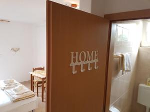 a bathroom with a door with the words homeurt on it at APARTMANI TONI POCE 2 in Primošten +50 photos