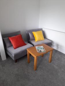 a living room with two couches and a coffee table at Bosloe in Helston