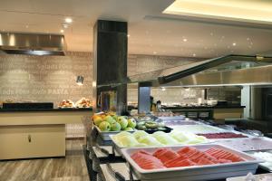 a buffet line with fruits and vegetables on display at Alameda Apartments in Benidorm
