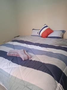 a bed with two towels sitting on top of it at La casa de Chepita in Cusco