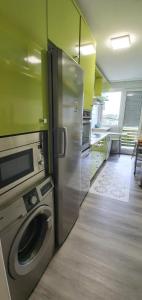a kitchen with a stainless steel refrigerator and a microwave at Preciosa vivienda vacacional, bien situada. 
