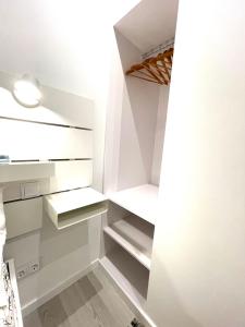 a room with white walls and white shelves at Beach House Old Town in Cascais