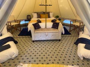 A bed or beds in a room at Eakley Manor Farm Glamping