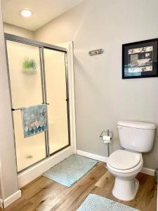 a bathroom with a toilet and a glass shower at Yosemite Escapes - Pine Mountain Lake in Groveland