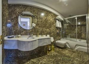 a bathroom with a sink, toilet and bathtub at Glorious Hotel in Istanbul