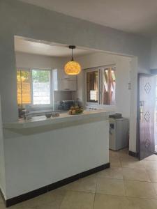 a kitchen with a white counter top in a room at Wimbi Cottage in Nungwi