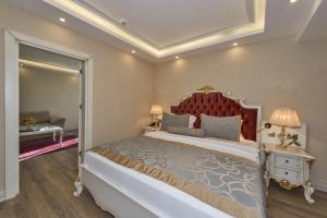 a large bed in a bedroom with a white bedspread at Glorious Hotel in Istanbul
