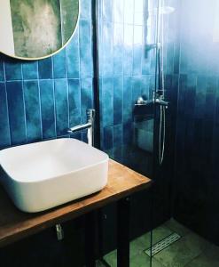a bathroom with a white sink and a shower at Elena’s apartments in Perivólion