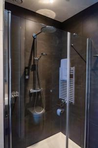 a shower with a glass door in a bathroom at Hotel Brasserie Florian in Wijk bij Duurstede