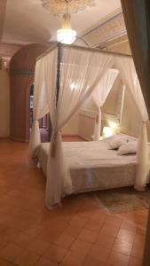 a bedroom with a bed and a canopy at Riad Puchka in Marrakesh