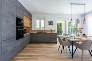 a kitchen with a table and a dining room at Villa Una in Krk