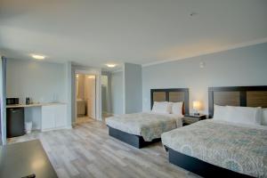 Ένα ή περισσότερα κρεβάτια σε δωμάτιο στο Dhimas Bayview Suites