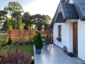 a patio with a table and chairs in a garden at Eko Dolina Kluki in Kluki