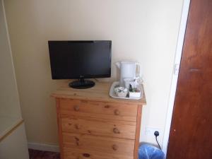 a television sitting on top of a dresser at The Sandhill in Sandown