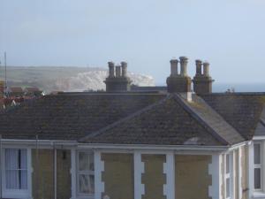 a roof of a house with mountains in the background at The Sandhill in Sandown