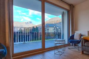a living room with a large sliding glass door at Appartement 60M2 - TELECABINE SAINT GERVAIS - 201 in Saint-Gervais-les-Bains