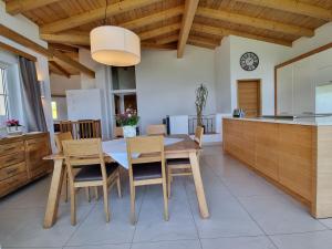 a kitchen and dining room with a wooden table and chairs at Appartment Schwarzenauer in Mutters