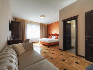 a living room with a couch and a bed at Boutique Central in Sibiu