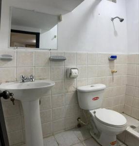 a bathroom with a toilet and a sink at Acogedor, amplio a 5 min de Las Palmas-Esmeraldas in Esmeraldas +23 photos