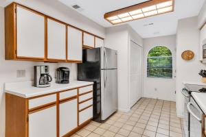 a kitchen with white counters and a refrigerator at Suite Spot at the Foothills condo in Branson