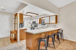 a kitchen with a counter and stools in it at Suite Spot at the Foothills condo in Branson