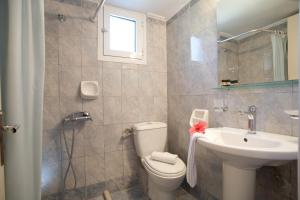 a bathroom with a toilet and a sink and a mirror at Jimmy's House in Nikiana +48 photos