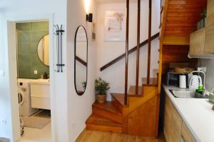 a small kitchen with a sink and a stairway at Apartman Paula in Milna