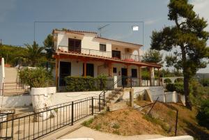 a white house with a staircase in front of it at Villa Zaharo and Lilian Apartments in Troulos