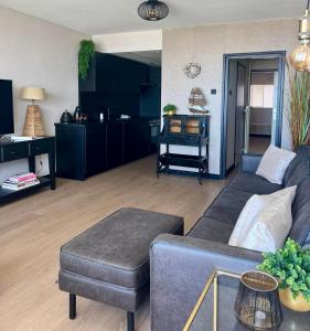 a living room with a couch and a table at Apartment Pascalle in Zandvoort