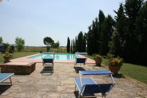 a patio with chairs and a swimming pool at Villa Cantagallo in Cortona