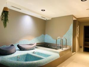 a bath tub with two faucets in a bathroom at Hotel Saalbacher Hof in Saalbach-Hinterglemm