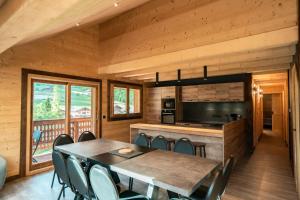 a dining room and kitchen with a table and chairs at CHALET LES CERFS in Châtel