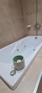 a bath tub with a bowl sitting on top of it at Puerto La Casa in San Martín de los Andes +60 photos