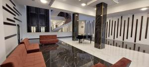 a lobby with chairs and a piano in a building at Via Tsaghkadzor in Tsaghkadzor