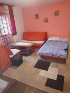 a room with a bed and a couch and a table at Zelena Oaza in Visoko