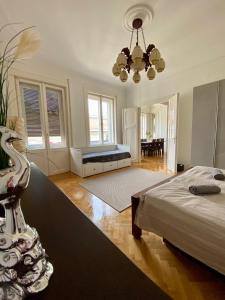a large bedroom with a bed and a chandelier at Deluxe Downtown Apartment with a Fabulous View in Budapest