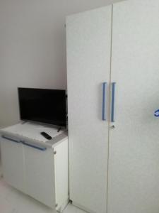 a white refrigerator with a tv on top of it at Apartment Villa Bajna in Živogošće