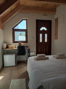 a bedroom with a bed and a desk and a window at Monte Pino Lux Apartments in Žabljak