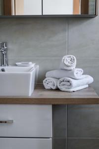 a bathroom with towels on a counter next to a sink at Ferienhaus Mörtl in Tröpolach +26 photos