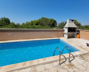 a swimming pool on top of a house at Apartments Bagić in Vir