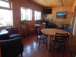 a dining room with tables and chairs and windows at Alpine Inn in Pagosa Springs